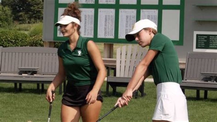 Meadow Rolence is holding the golf stick in the picture.