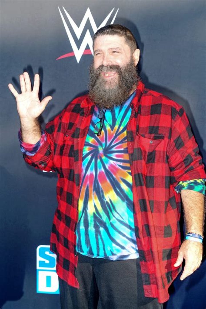 Mick Foley: The Many Characters of the WWE Superstar 4 Mick Foley in 2019 wearing a tie-dye shirt like his character, Dude Love