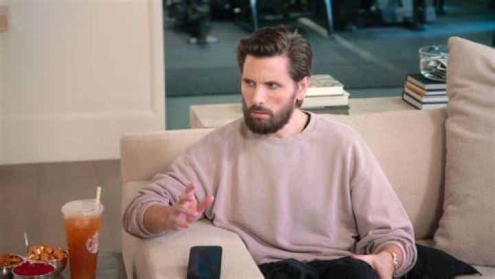 Scott Disick is sitting in his luxury car outside the garage.
